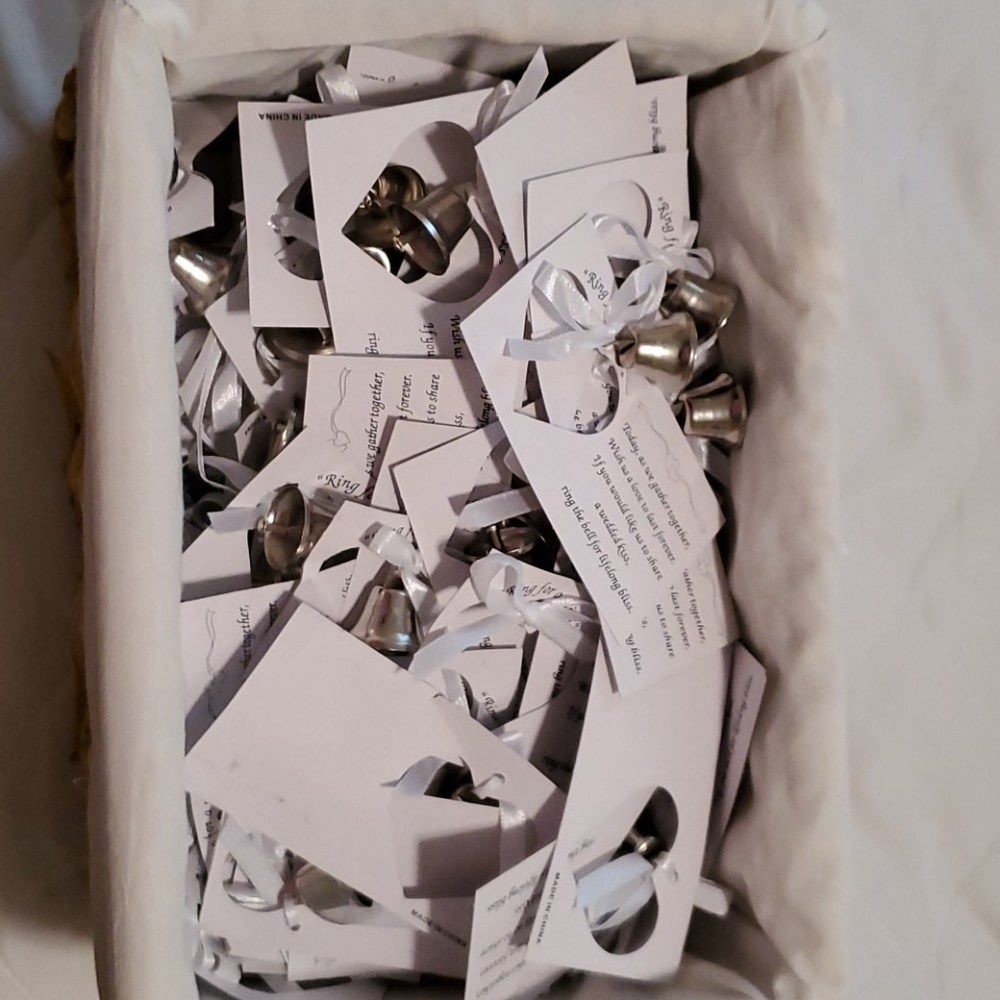 Basket of wedding bells attached to cards.